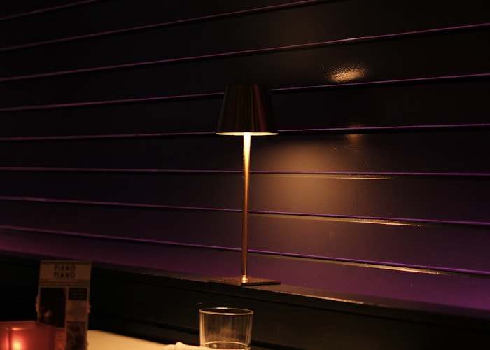 Intimate candlelit dining room booth at Ember & Ash